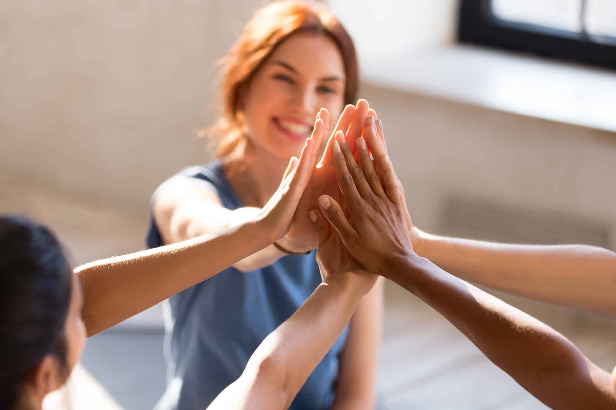 a woman high fives children