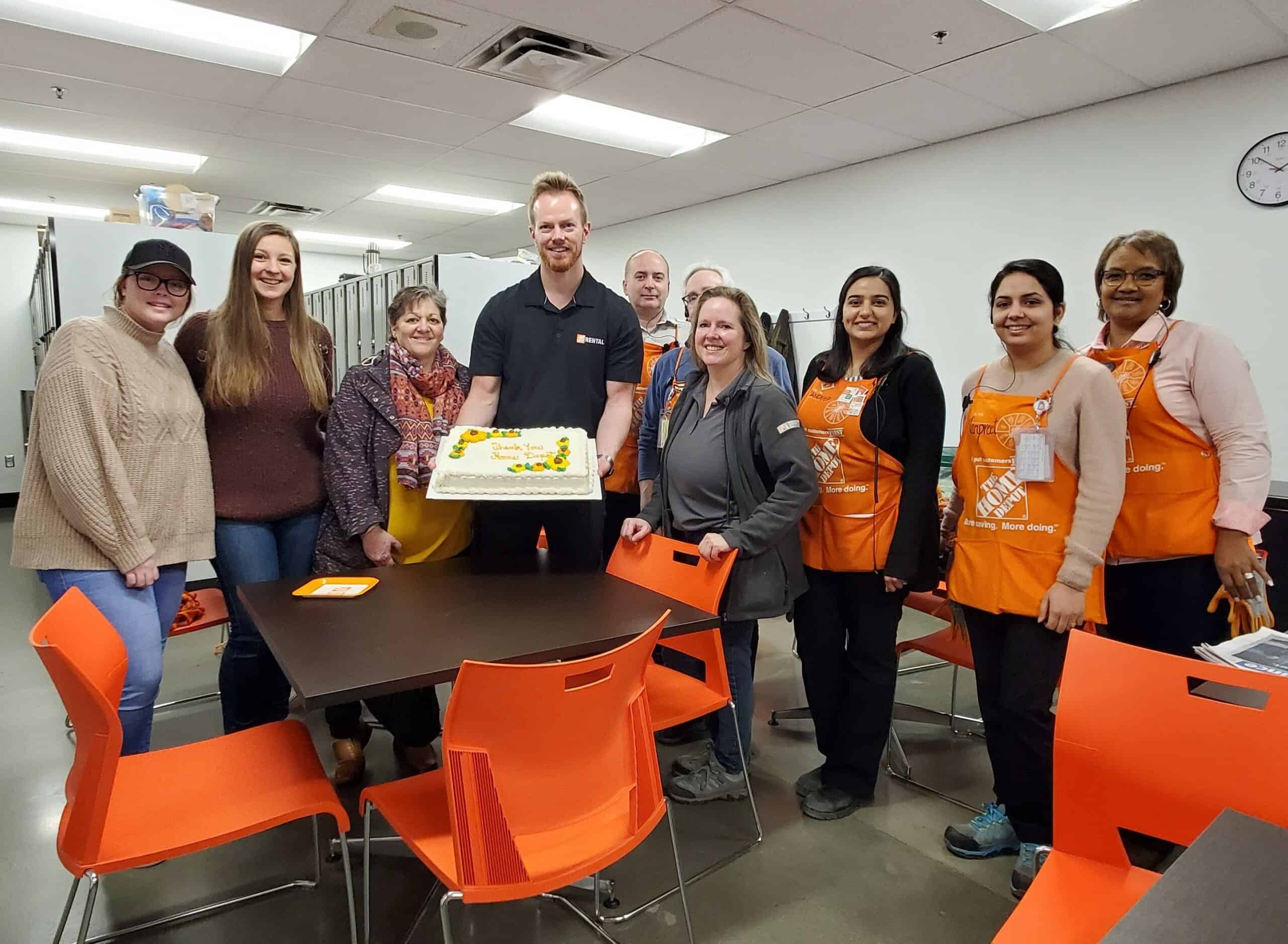 YRC & Home Depot Home Depot employees holding a cake