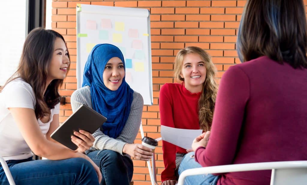 group of multicultural women attending a community meeting