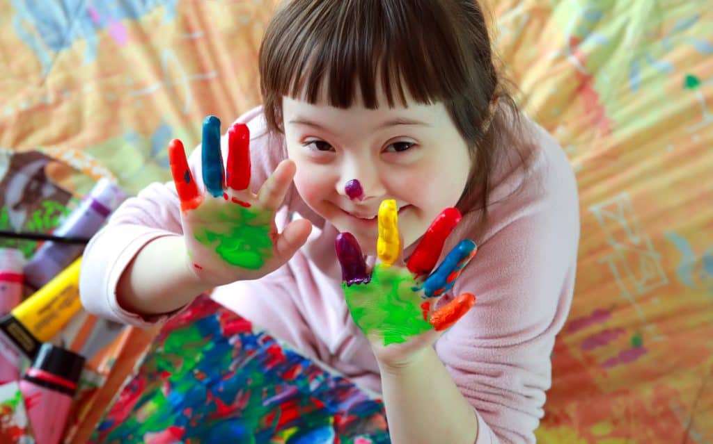 little girl with painted hands