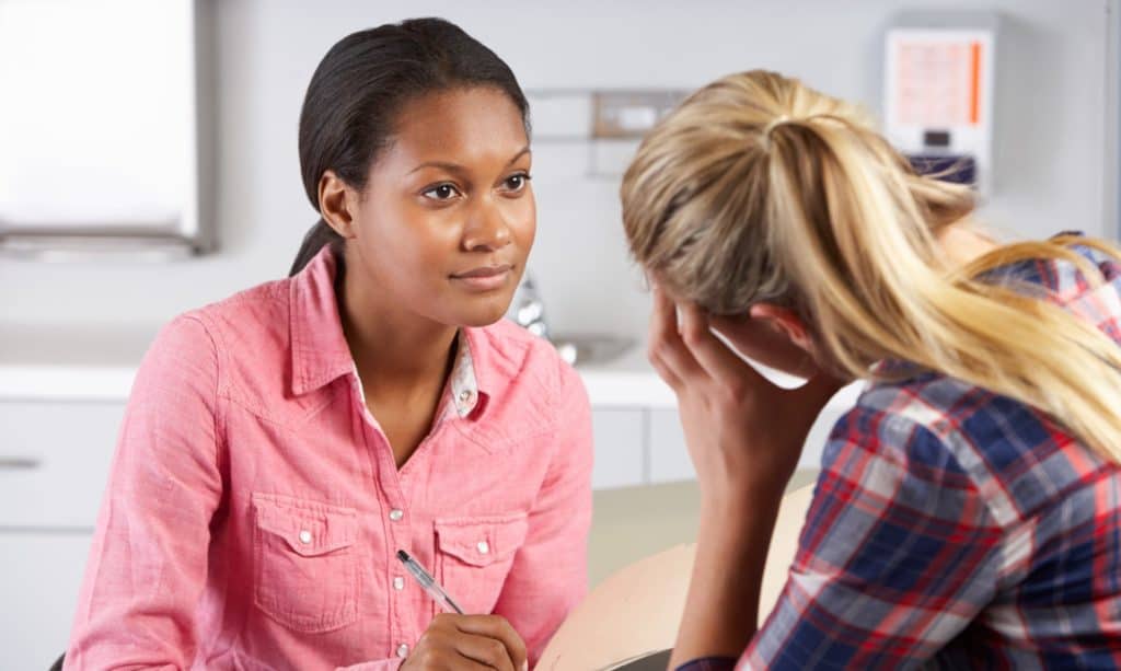 counsellor helping a tramatized patient in therapy