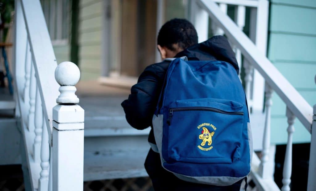 young boy with a starfish pack backpack