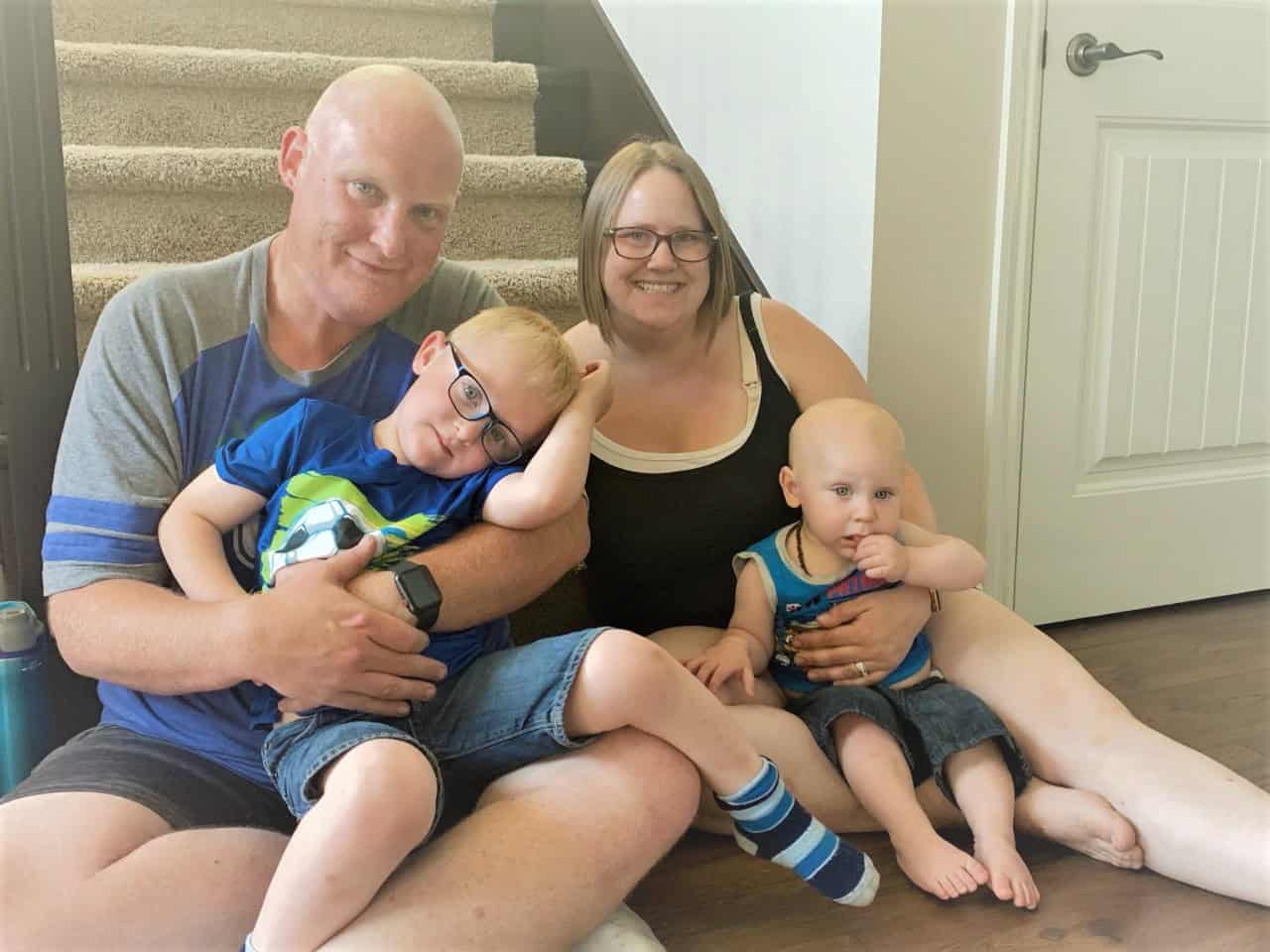family of four sitting on the ground