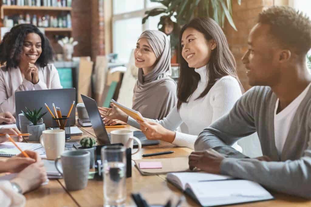 Group of people discussing and working at a desk