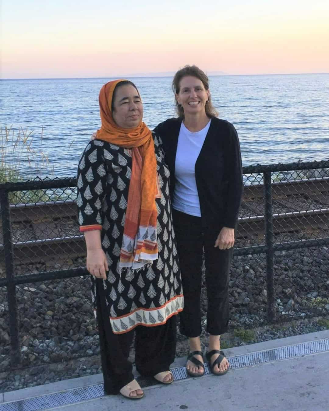 Two women standing close to each other in White Rock, BC