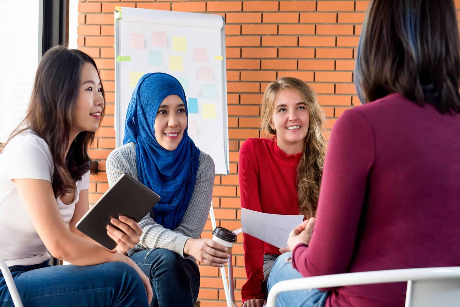 group of multicultural women attending a community meeting