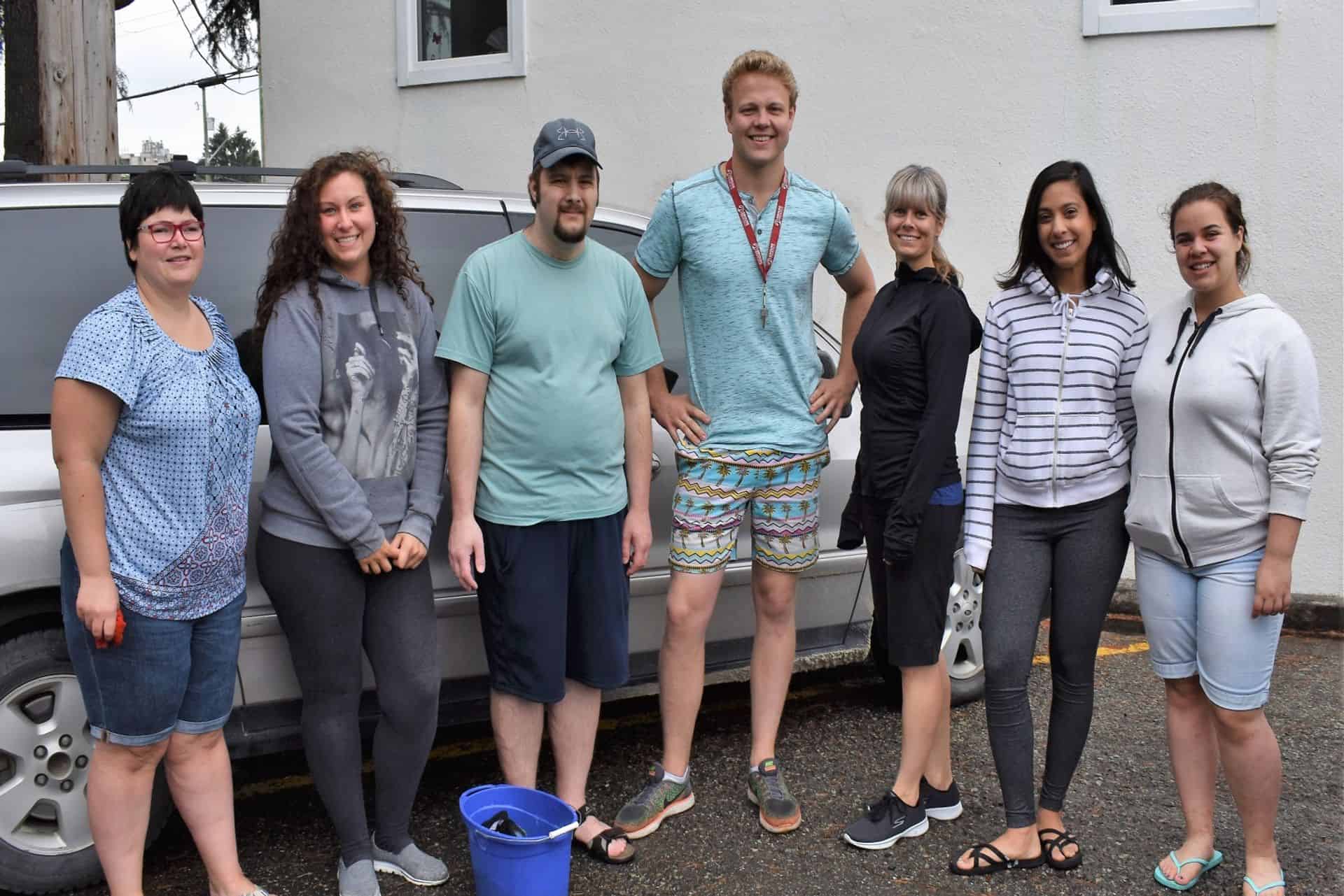 adults with diverse abilities about to wash a car