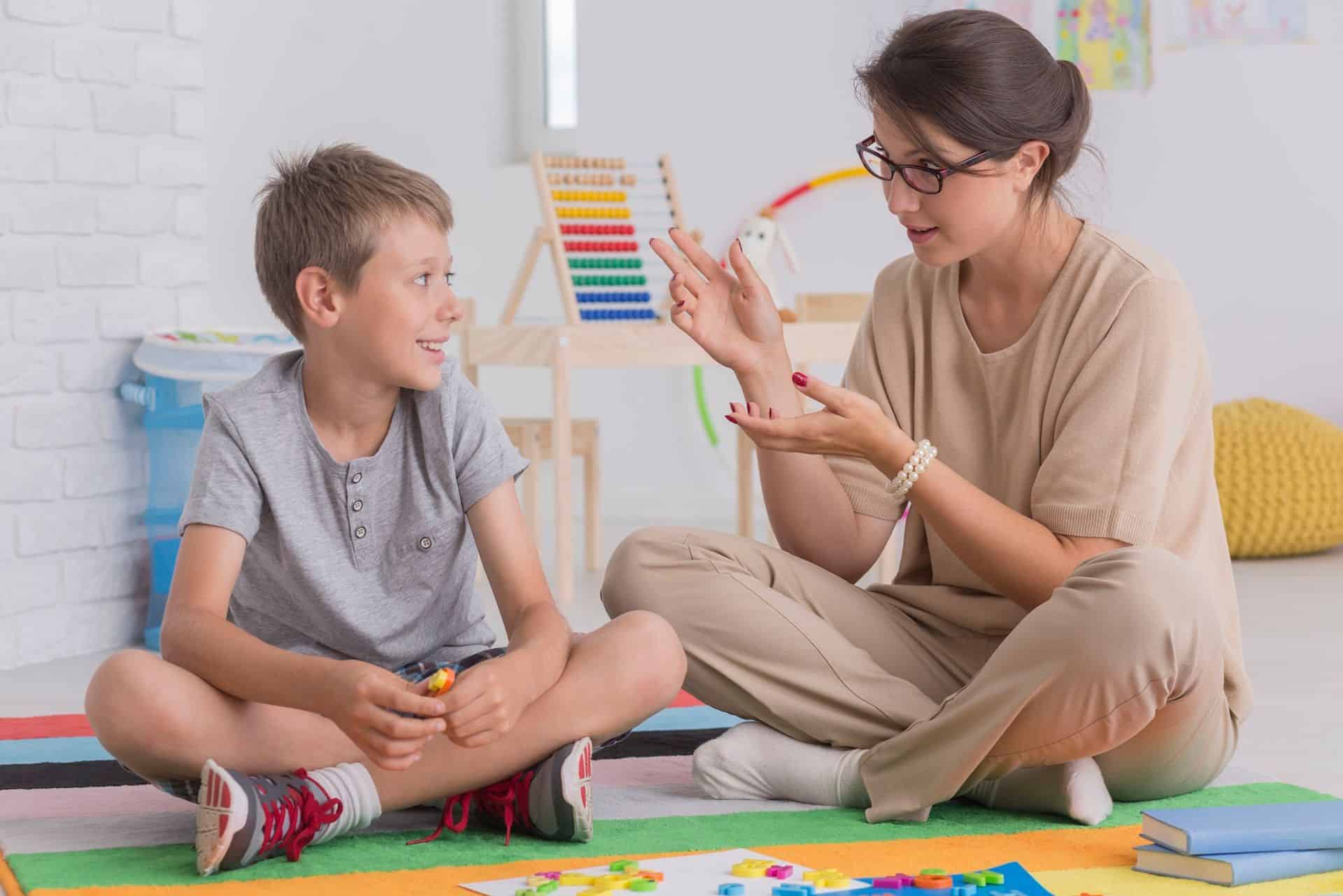 Parents sitting on floor with their children in a parenting class