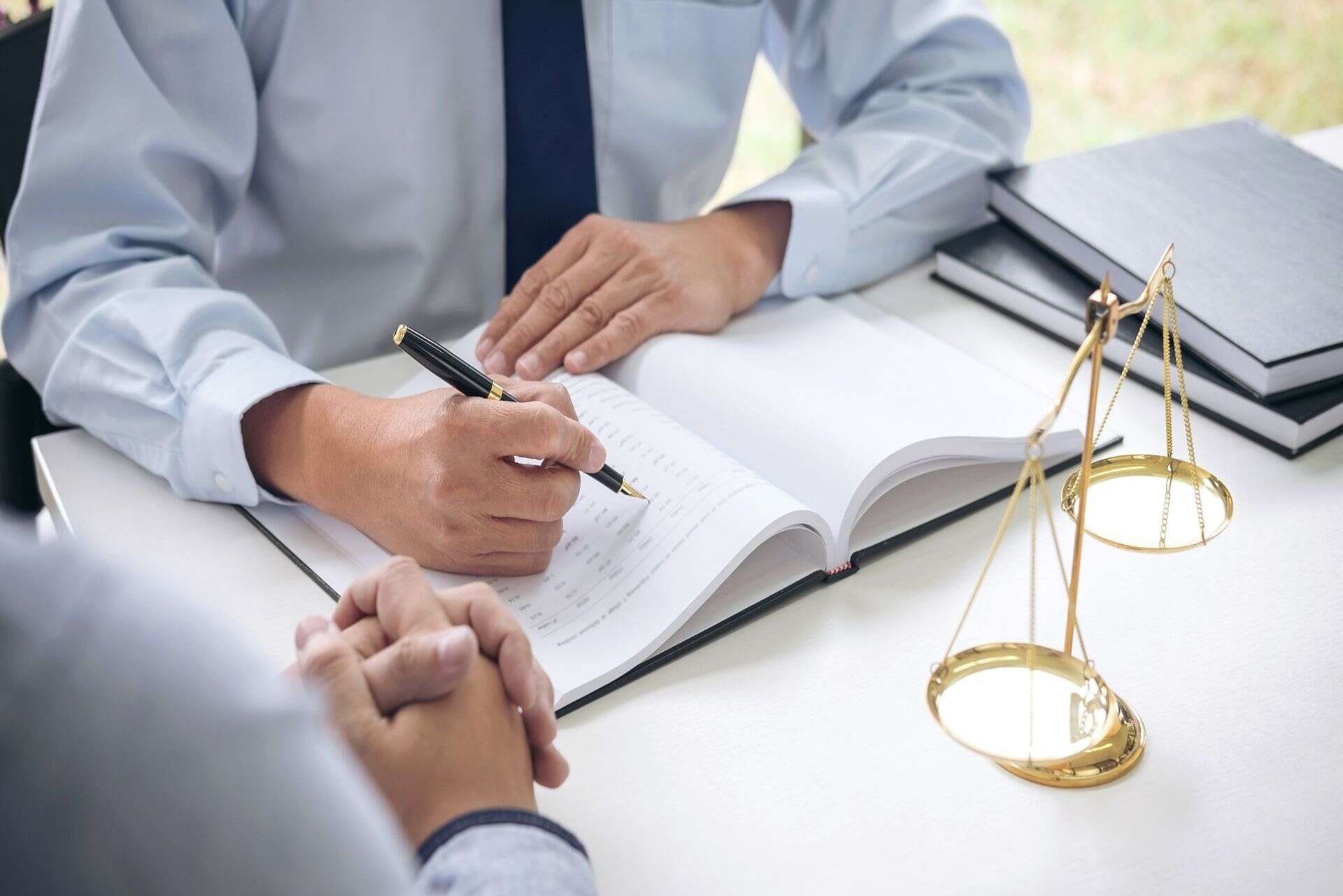 woman places hands in shape of heart on pregnant belly