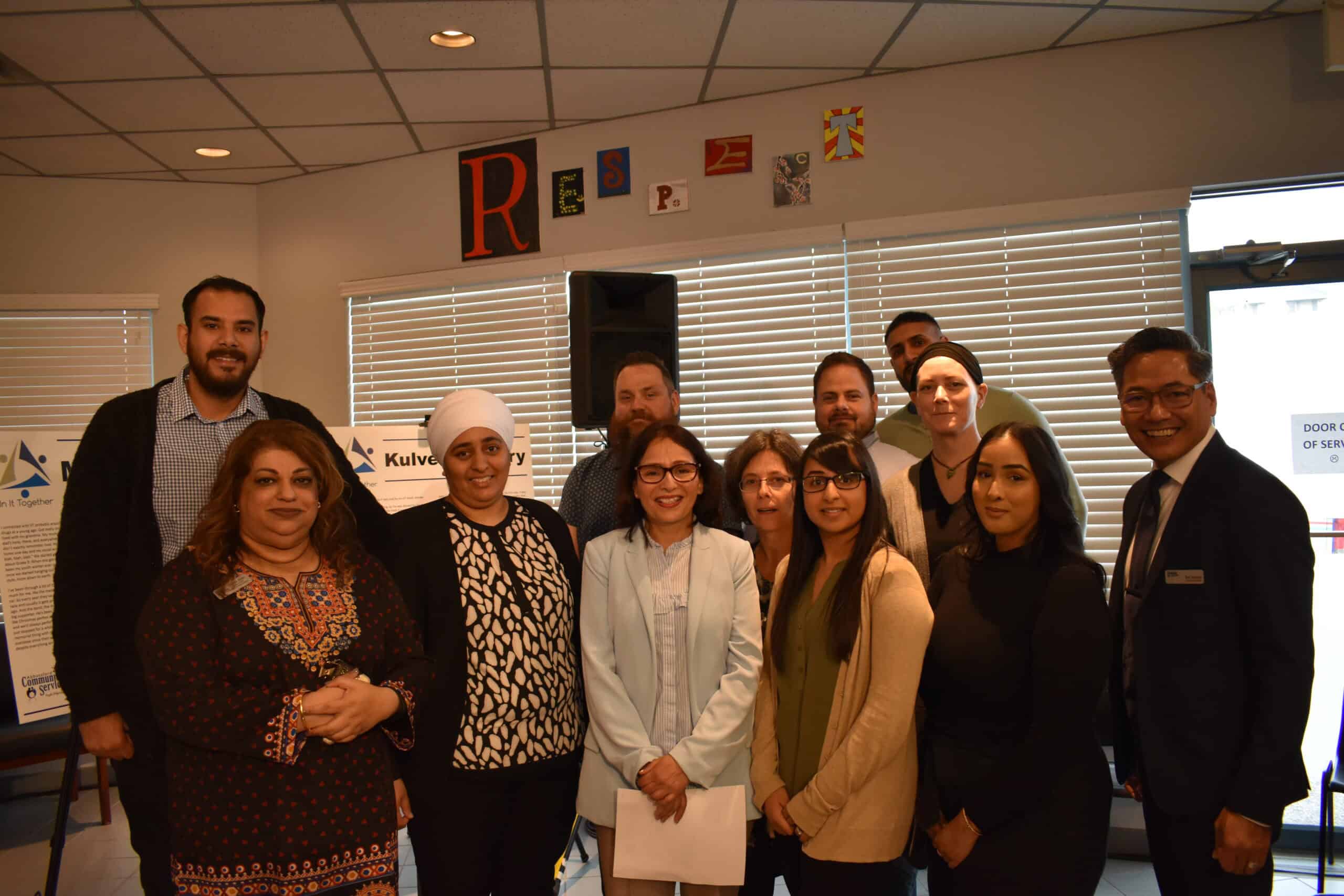 A diverse lineup of In It Together staff alongside Rod Santiago, pose for the camera.