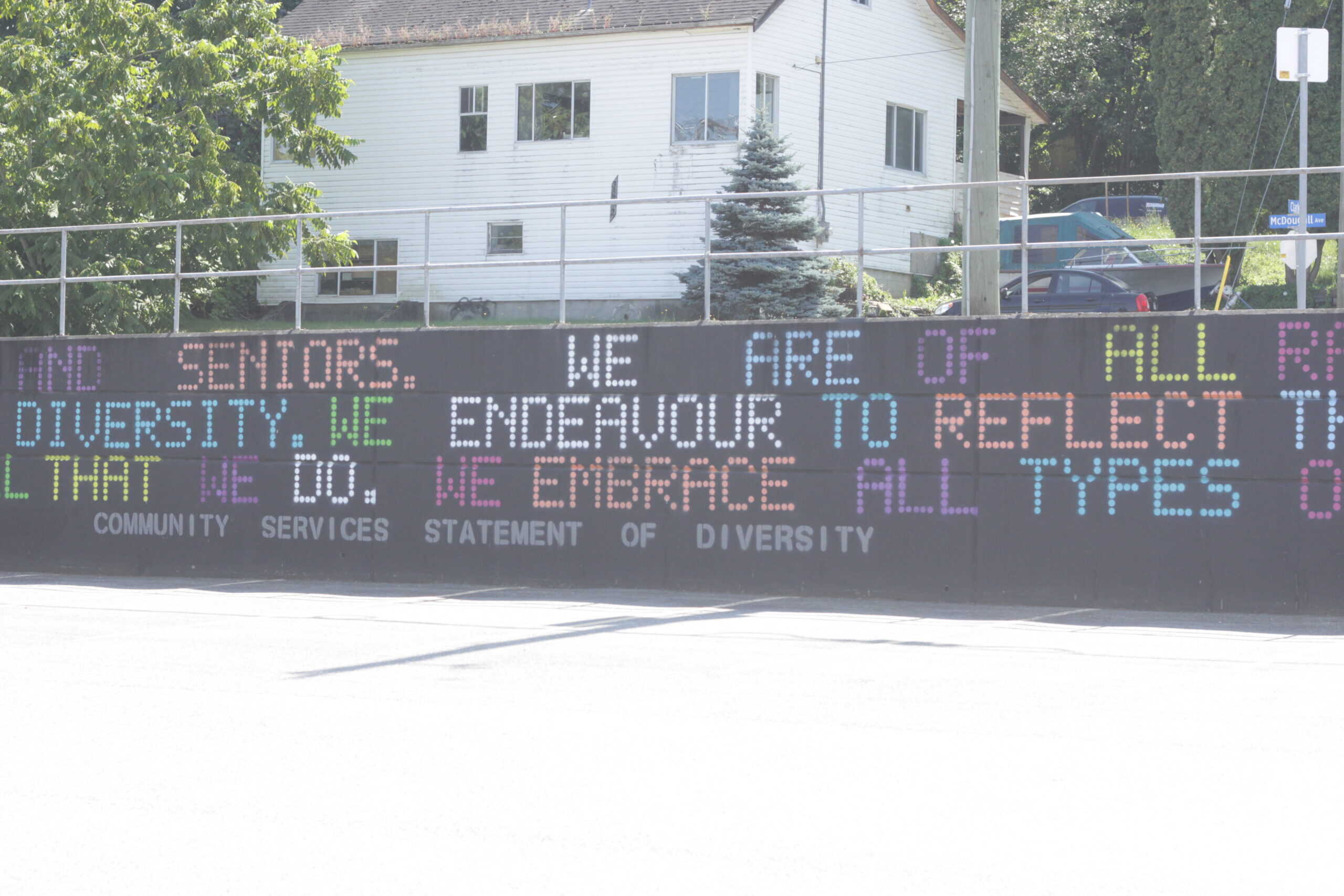 A picture depicting the concrete wall outside Archway which has the Statement of Diversity painted on it.