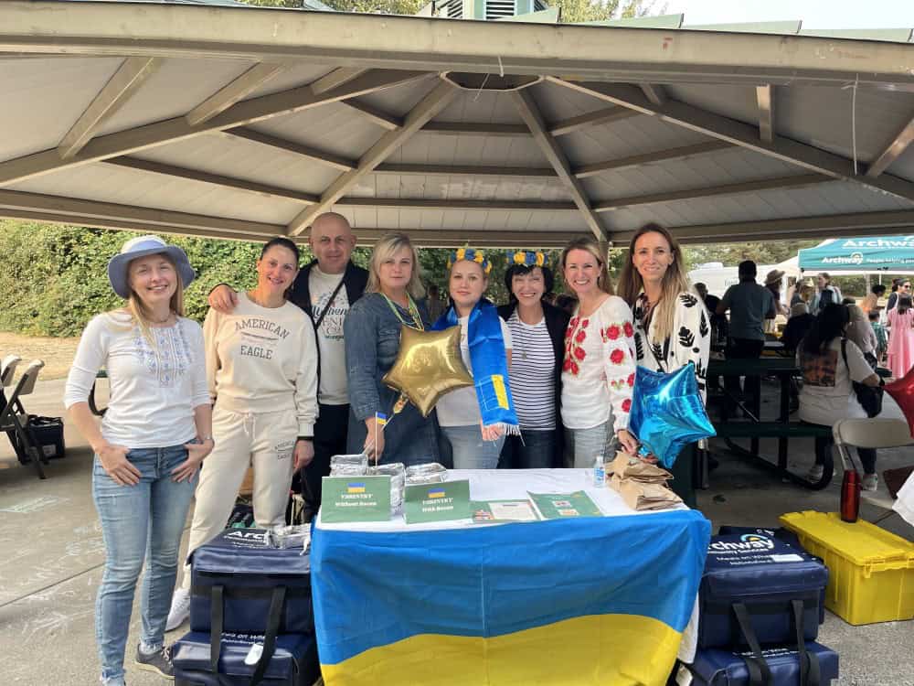 Group of people at Ukrainian table at community event