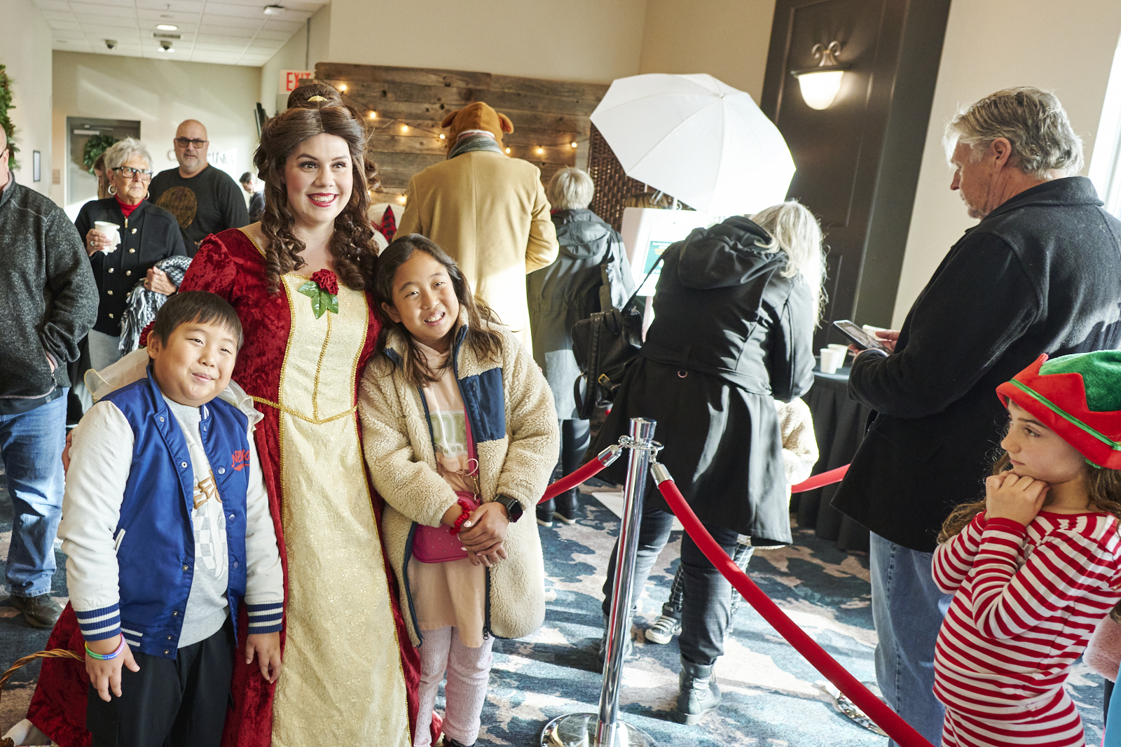 Princess poses with two children at her side at event