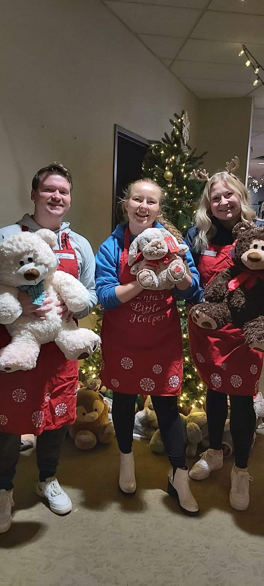 two girls stand behind carboard boxes and smile at camera