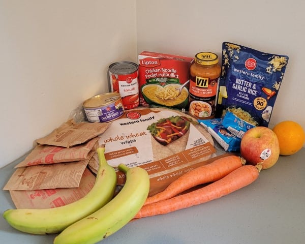 Group of fresh vegetables and packaged foods on a table