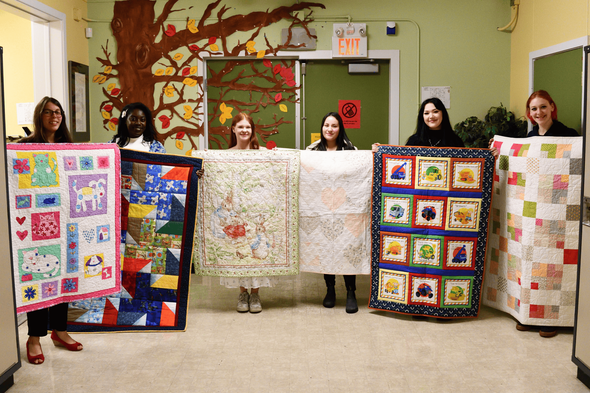 New Beginnings Young Parent Program graduates with their quilts