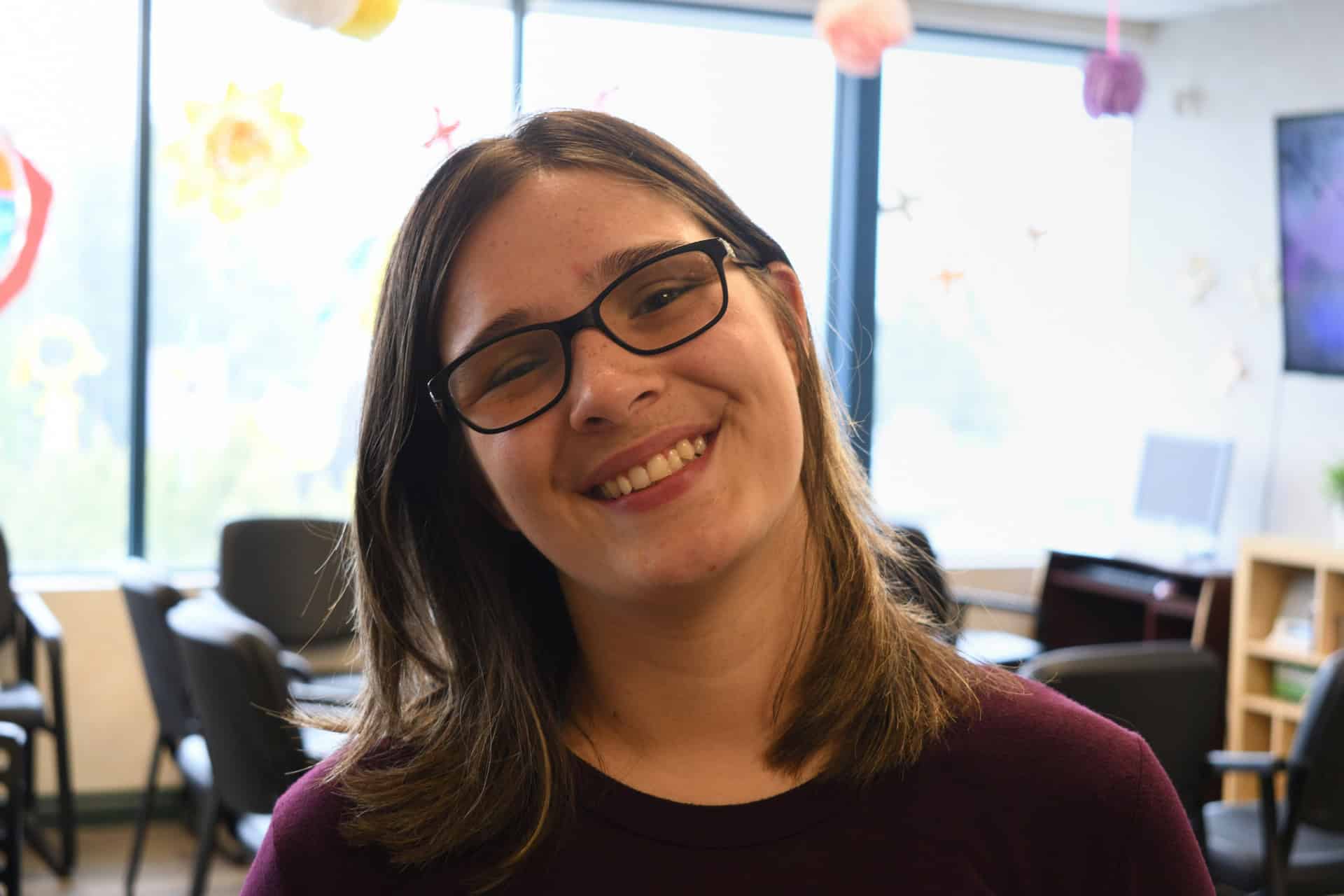 two young girls wearing hijabs pose with arms around each other