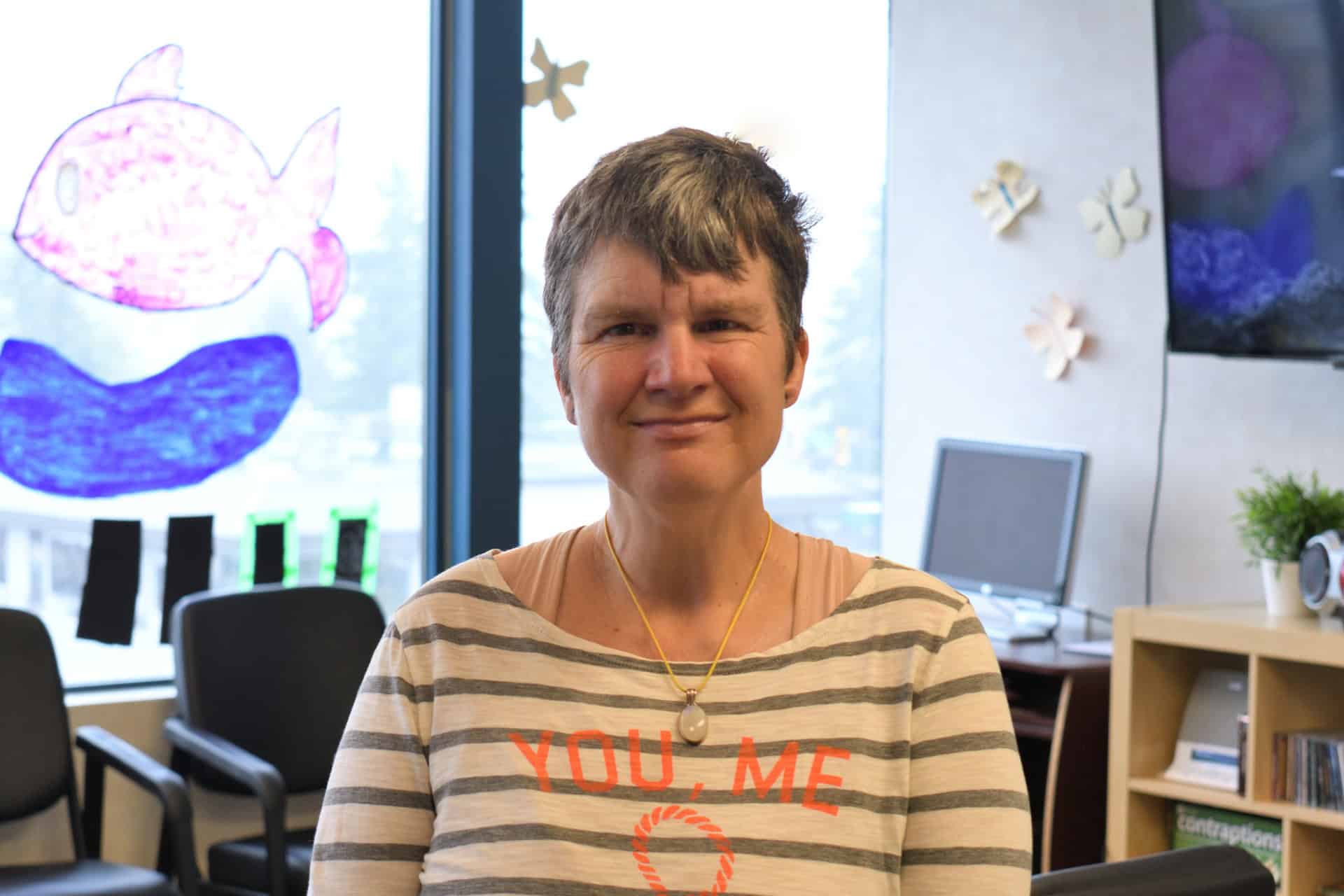 two young girls wearing hijabs pose with arms around each other