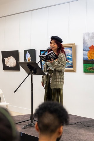 Asian woman speaking on stage