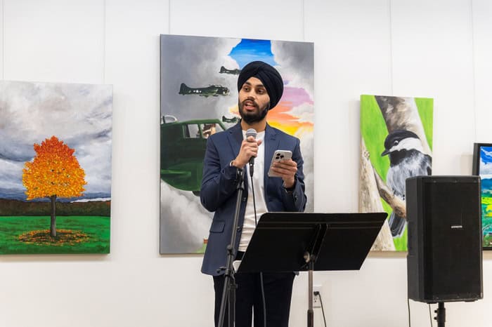 South Asian man in a turban speaking on stage