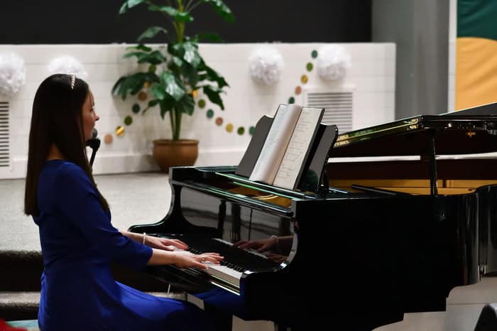 A young girl playing the piano