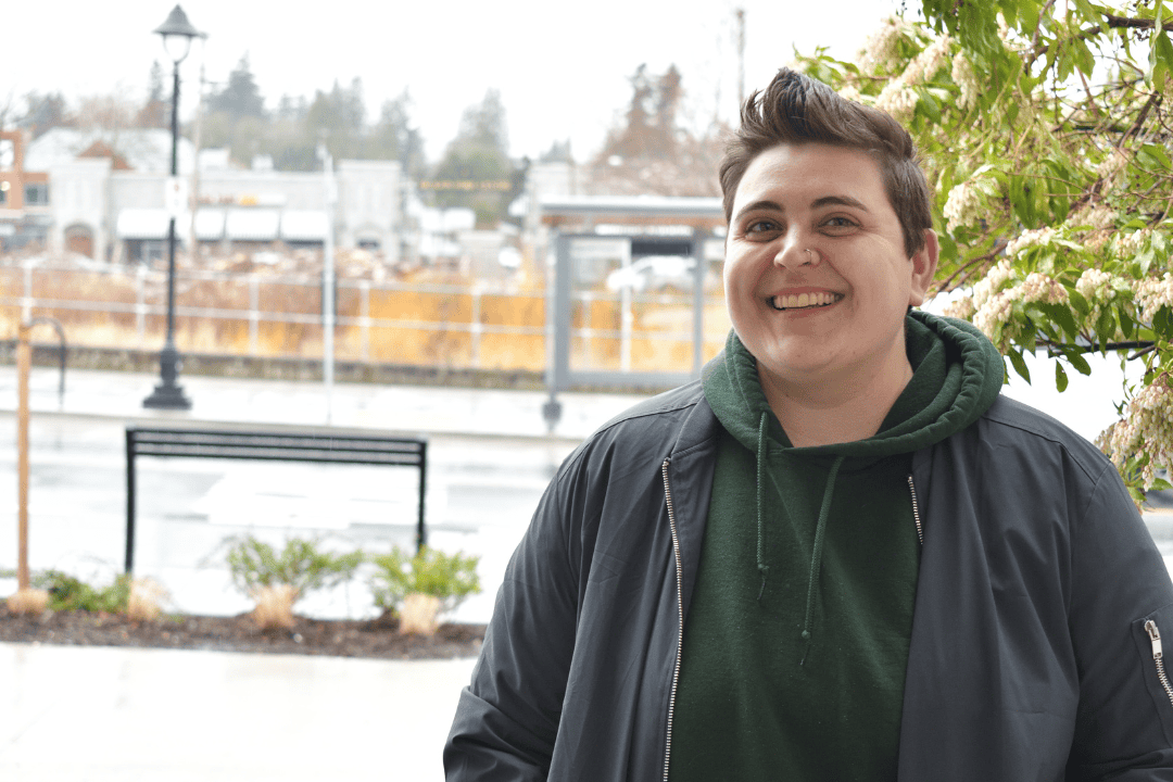 Headshot of a woman with street in background
