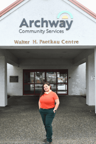 Woman poses in front of Archway Community Services building