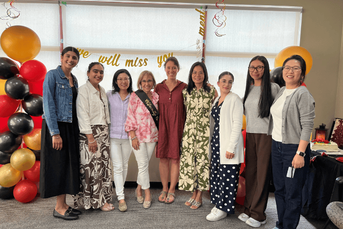 7 woman standing in a row posing for photo