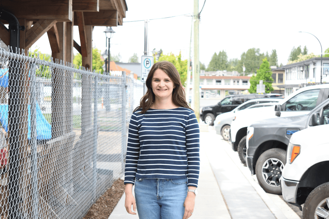 Jana standing on sidewalk beside Archway building