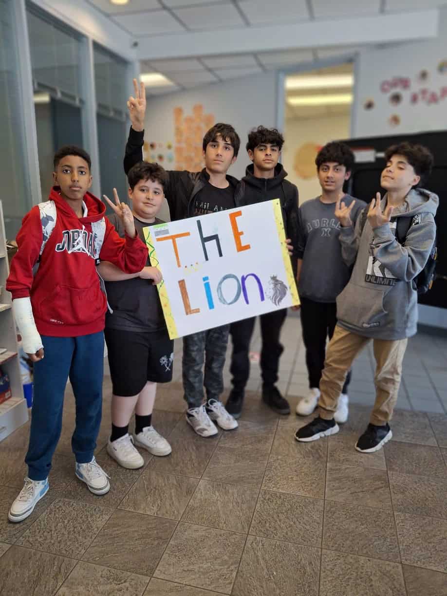 A group of children holding a sign