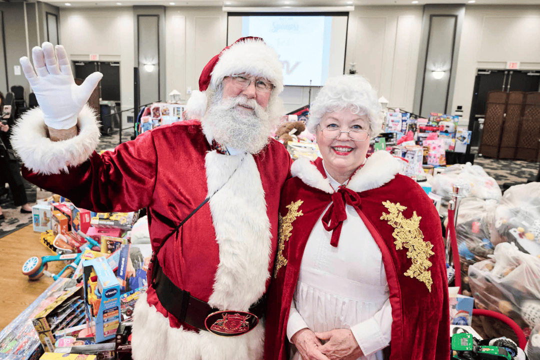 group of attendees pose with princesses and frosty mascot