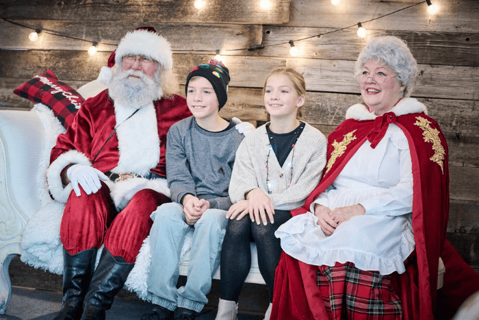 Toys for Tots view of toy pile, attendees and performers from behind the stage