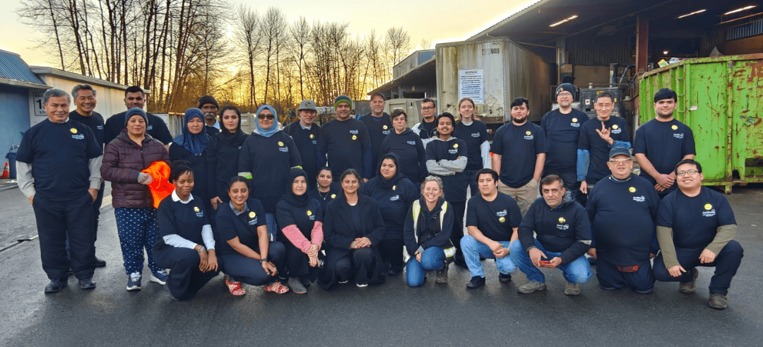 Large group of people standing together smiling at camera standing on concrete
