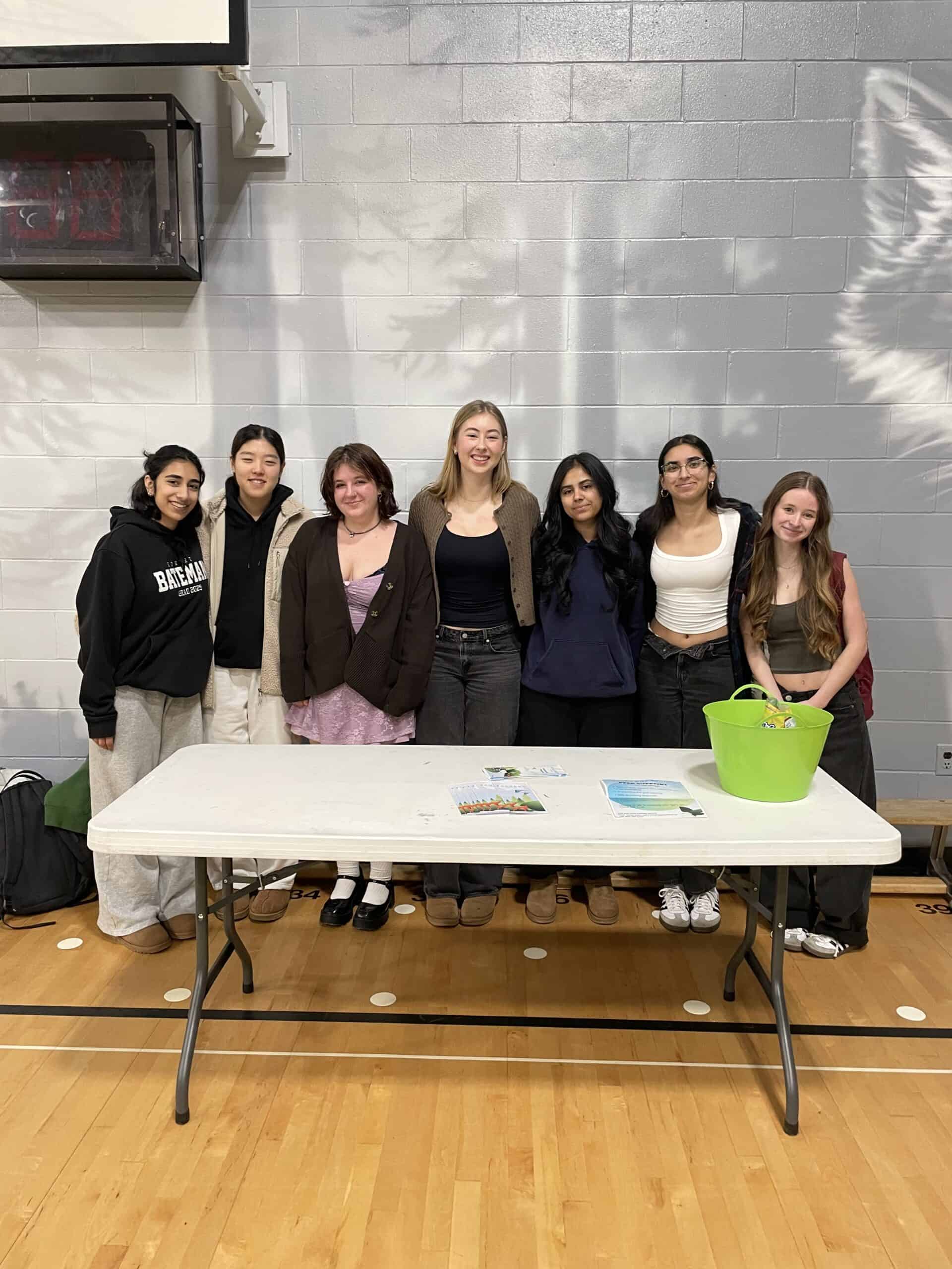 Alyssa and a group of ambassadors at a booth