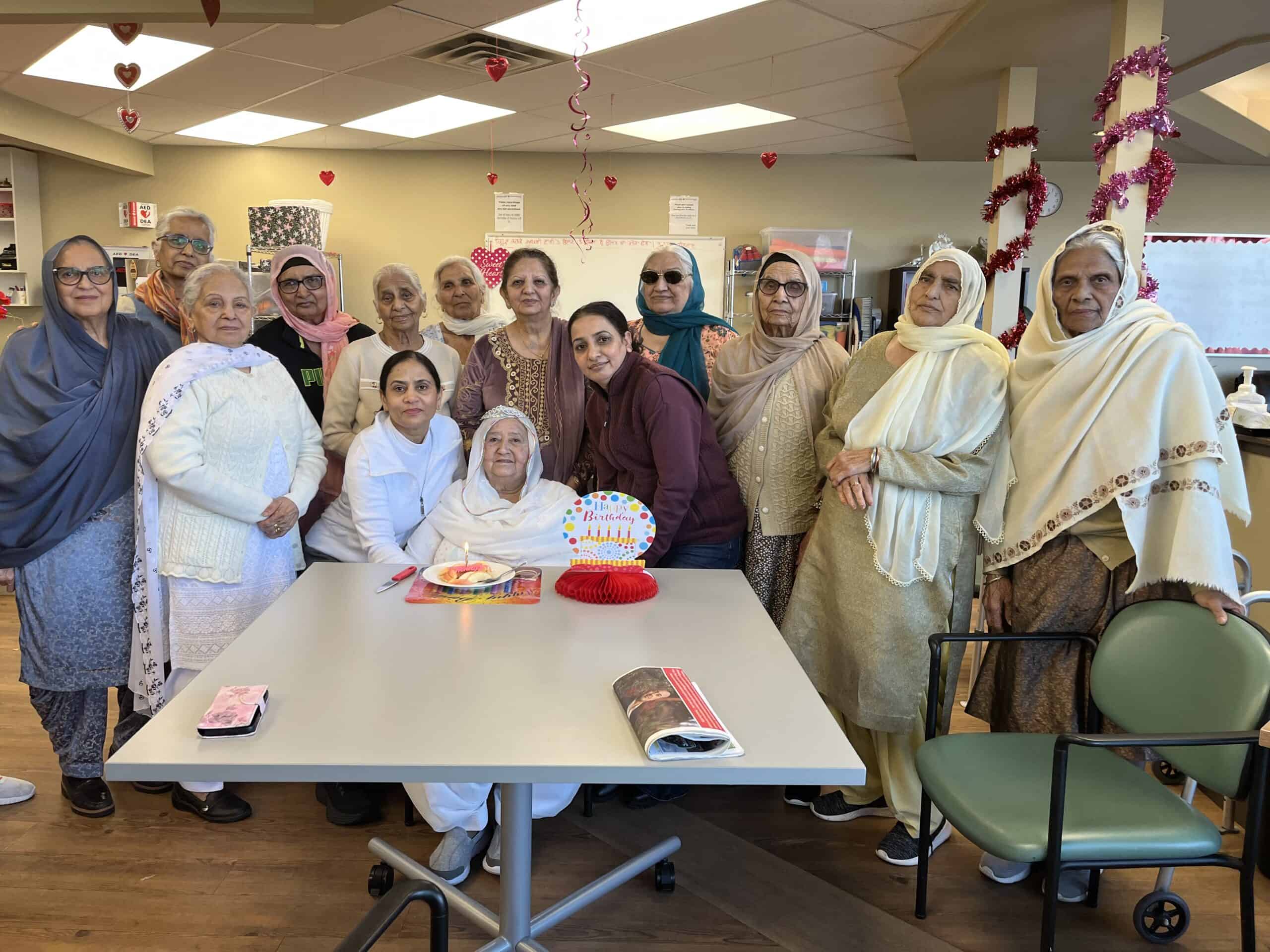 Baswinder celebrating a participant's birthday with other seniors in the program