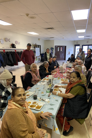 Program participants eating lunch and smiling