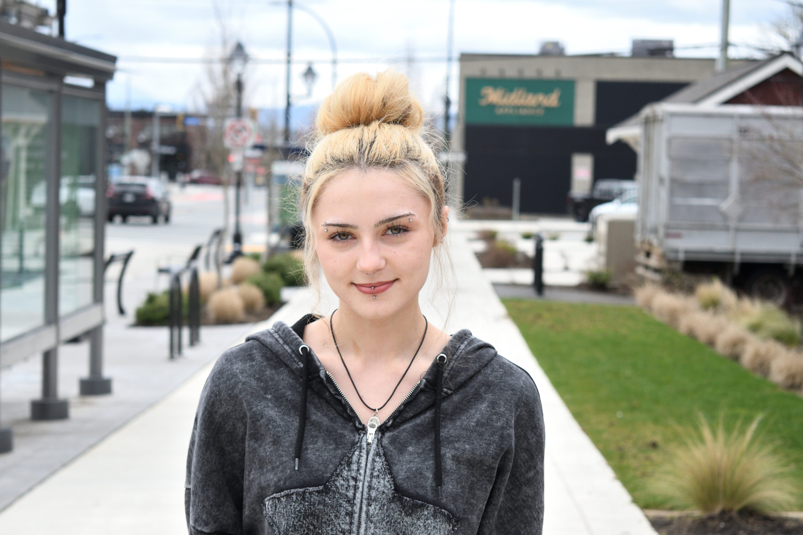 Hailey, a past Starfish Client turned champion, poses on a street. 