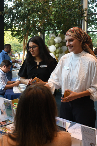 Event organizer Abhinoor Sidhu (left) and colleague Mirela Gigovic (right) thank service providers for attending.