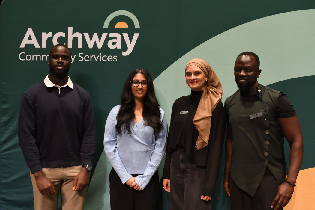 Group of 4 diverse individuals posing for a picture
