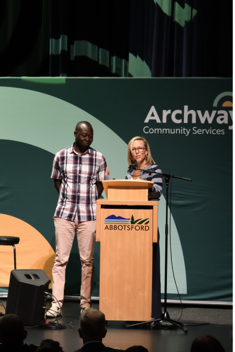Man and women speaking on stage